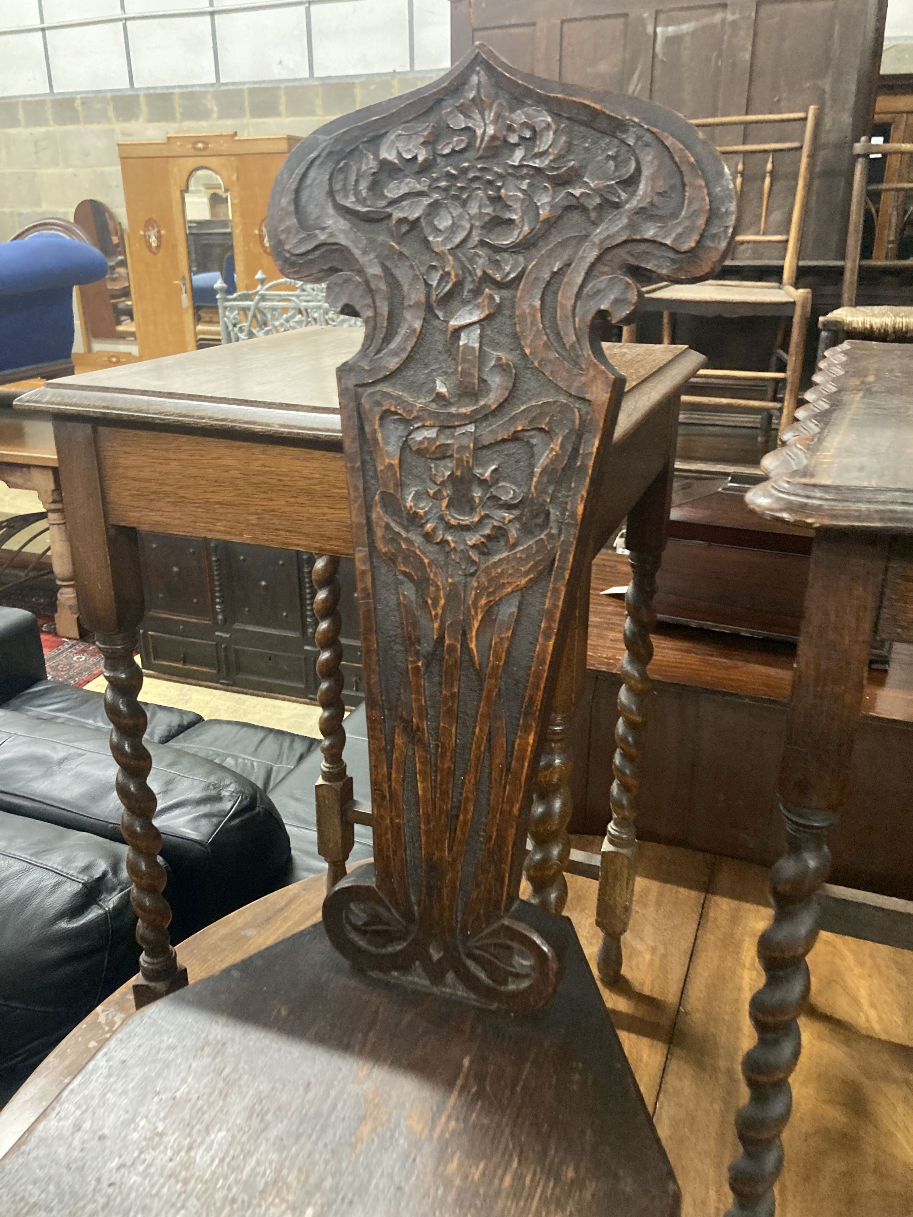 Two 1920s oak occasional tables, larger width 60cm, depth 37cm, height 72cm, together with a carved oak spinning chair